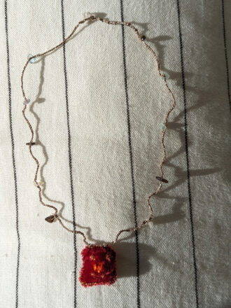 Red necklace with golden pink thread