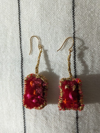 Red earrings with golden thread